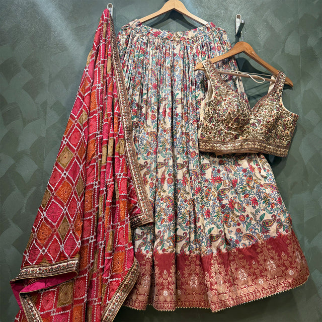 Ivory paisley print lehenga with gold-trim blouse and red bandhej dupatta