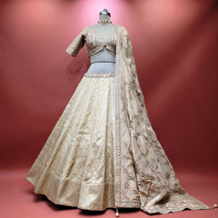 Ivory Banarasi lehenga on mannequin, detailed bodice blouse and flared skirt