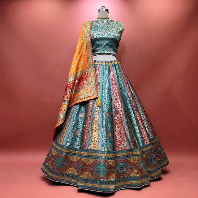 Multicolour woven lehenga with teal-blue skirt and red-orange ornamental border