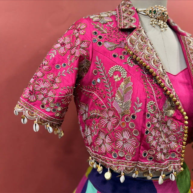 Rani pink mirror-work jacket with embroidered floral motifs and tassel trim