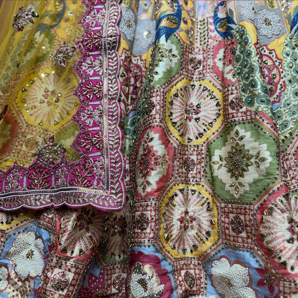 Close-up of multicolour Banarasi lehenga: octagonal medallion tiles with mirror and bead centres, fuchsia dupatta border