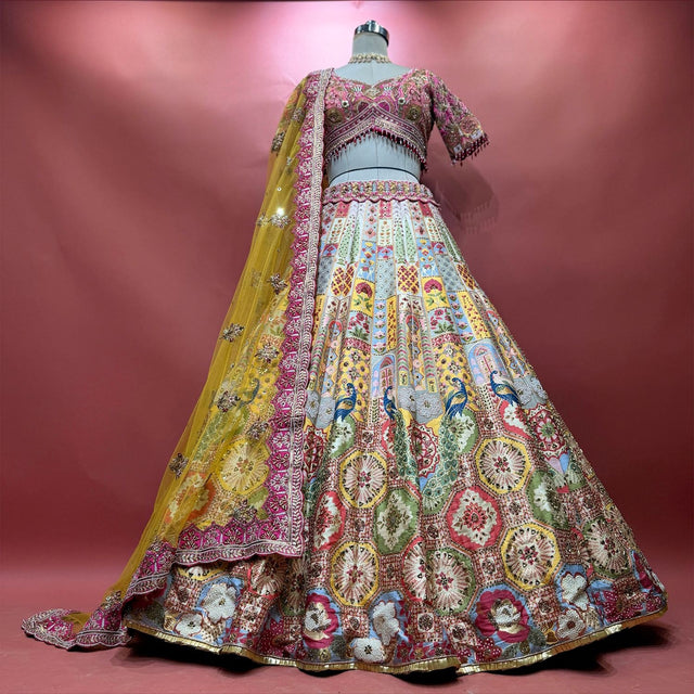 Multicolour Banarasi fusion lehenga with pastel jharokha panels, blue peacocks, medallion tiles and a yellow net dupatta
