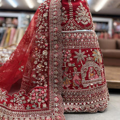 Deep red bridal lehenga skirt with ornate silver beadwork and embroidered border motifs
