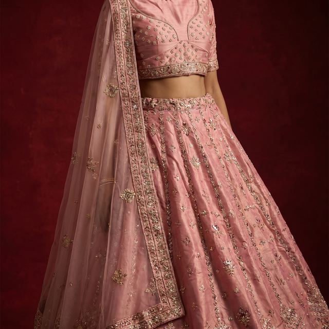 Pink blouse and lehenga with gold zardosi embroidery, glittering motifs, and scalloped waistband