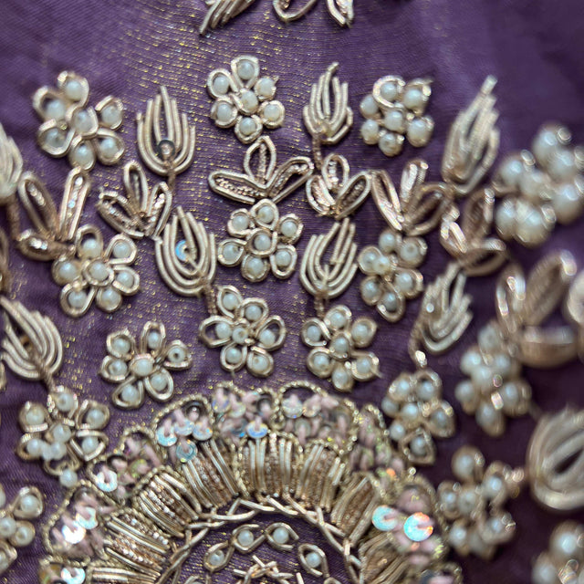 Lavender fabric with dense gold-toned floral and teardrop zardosi embroidery