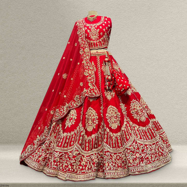 Royal red bridal lehenga with ornate gold-embroidered skirt and sheer drape