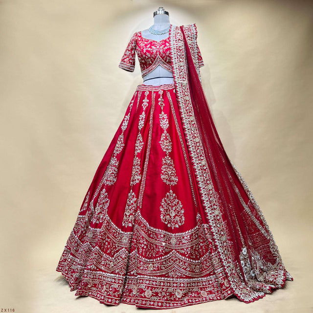 Red bridal lehenga with heavily embroidered hem, flared skirt, and matching dupatta border
