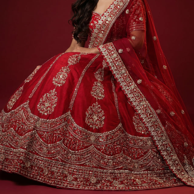 Red bridal lehenga with vertical Cutdana and pearl-like embroidery, ornate hem border
