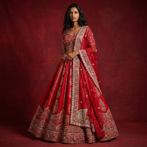 Red bridal lehenga with vertical cutdana and pearl-style embellishment, flared skirt