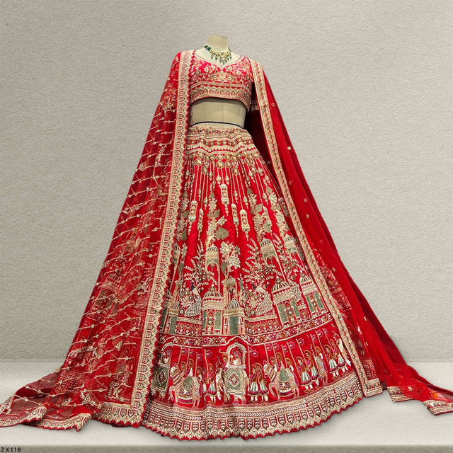 Red bridal lehenga on mannequin with ornate embroidered skirt and matching draped veil.