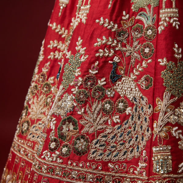 Red bridal lehenga with gold, green and pearl embroidery