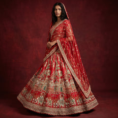 Royal red bridal lehenga with big flared silhouette and ornate gold embroidery
