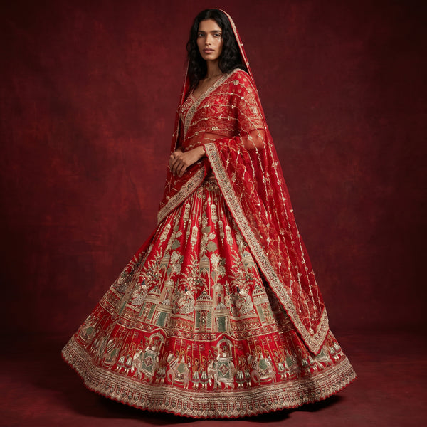 Royal red bridal lehenga with big flared silhouette and ornate gold embroidery