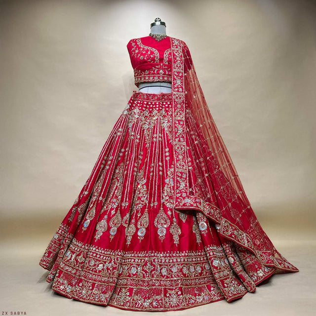 Royal red bridal lehenga on mannequin with full skirt and embroidered border