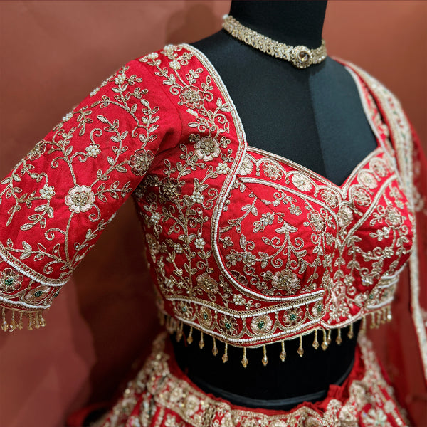 Red hand-embroidered bodice with gold motifs, scalloped trim, elbow-length sleeves