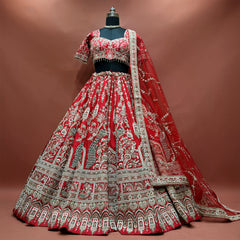 Red bridal lehenga set on a mannequin with peacock motifs, arched hem and net dupatta