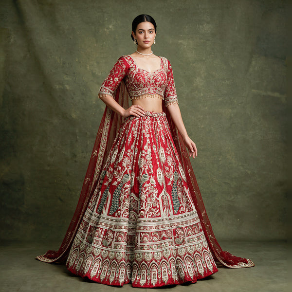 Red embroidered bridal lehenga with flared skirt and matching net dupatta drape