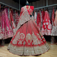 Red flared lehenga on mannequin with heavy silver-gold embroidery and embellished hem