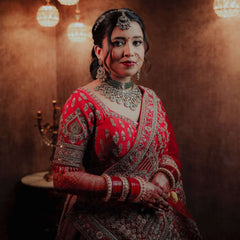 Red and dark bridal lehenga with silver-gold embroidered bodice and drape sash