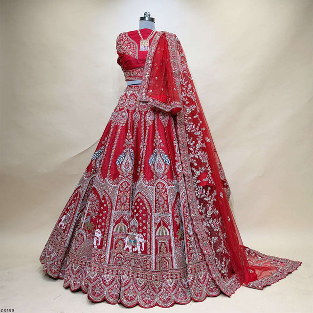 Red designer lehenga with detailed silver embroidery panels and matching dupatta