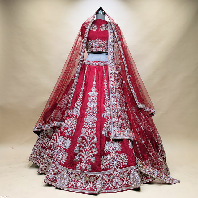 Embroidered bridal lehenga with vertical paneling, maroon skirt and silver bead details
