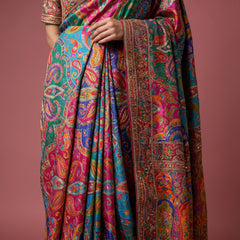 Close-up of teal blue multicolour saree pleats with detailed embroidered border
