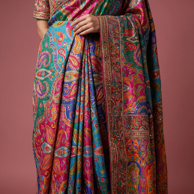 Close-up of teal blue multicolour saree pleats with detailed embroidered border