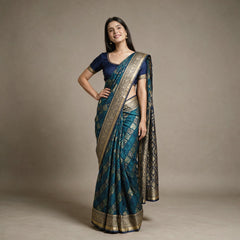 Model wearing the teal blue Banarasi art silk bandhni pattern gifting saree with zari paisley checks