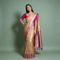 Banarasi Art Silk Gifting Saree with Meenakari Diamond Jaal & Rani Pink Border in yellow and rani pink, worn by a model