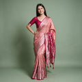 Banarasi Art Silk Gifting Saree with Parrot Medallion Border in peach and rani pink, worn by a model