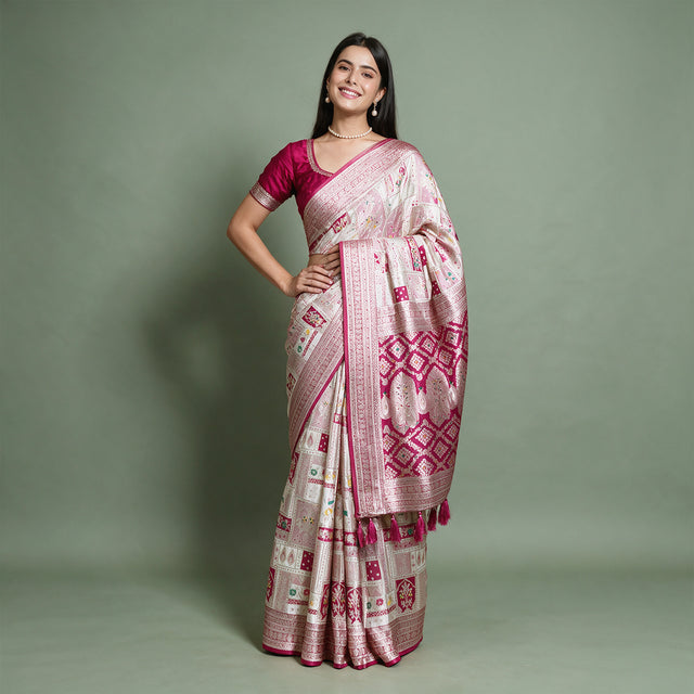 Banarasi Art Silk Gifting Saree with Patchwork Zari Weave & Rani Pink Border in white and rani pink, worn by a model