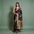 Black silk saree with velvet polka dots and gold zari border, pleated drape