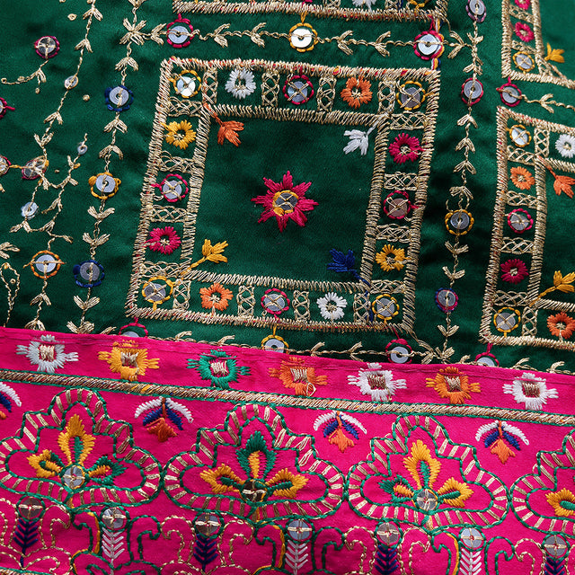 Bottle green saree close-up with embroidered geometric and floral resham, zari trim