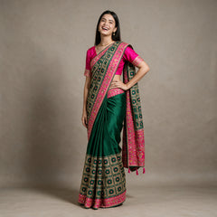 Bottle green silk saree with colorful resham and zari border, pink pallu border