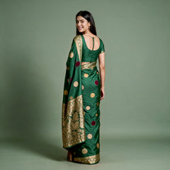 Bottle green silk saree with velvet polka dots and gold zari border, draped back view
