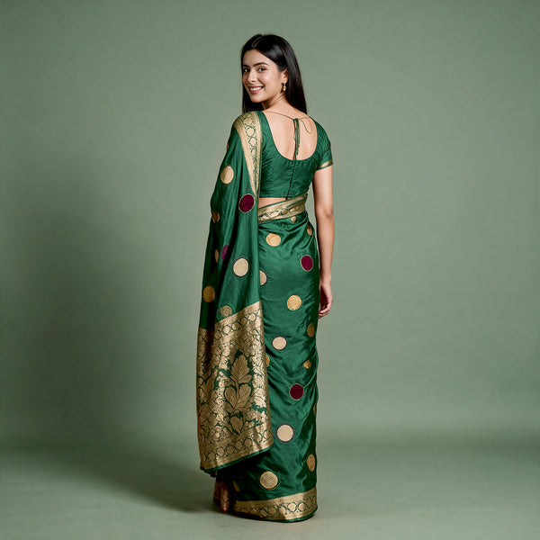 Bottle green silk saree with velvet polka dots and gold zari border, draped back view