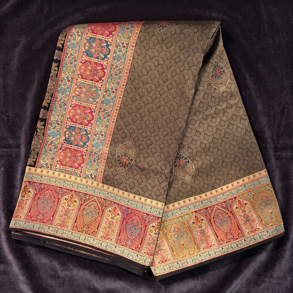 Brown dola silk saree with colorful kani-style arch border and floral motifs