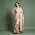 Champagne Viscose Silk Position Print Saree with Pastel Floral & Bird Border, worn by a model