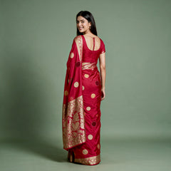 Cherry red silk saree with velvet polka dots, zari border, open-back drape