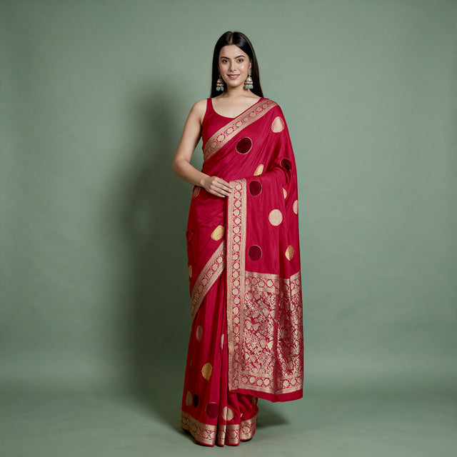 Cherry red silk saree with velvet polka dots and zari border, draped with pallu