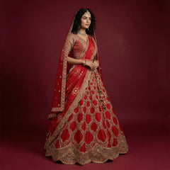 Royal red bridal lehenga with gold embroidery, flared skirt, and double dupatta