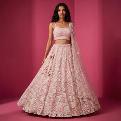 Blush pink net bridal lehenga with white cutdana embroidery, sleeveless blouse and flared skirt
