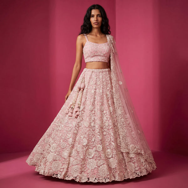 Blush pink net bridal lehenga with white cutdana embroidery, sleeveless blouse and flared skirt