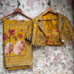 Mustard floral printed saree with embellished border and matching jacket blouse