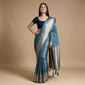 Satin Gifting Saree with Zari Elephant Border in teal, worn by a model