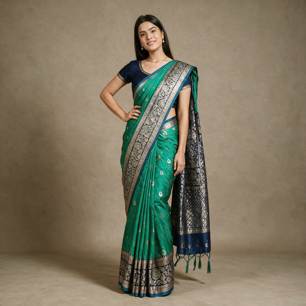 Emerald Green Banarasi Art Silk Saree with Zari Butis & Navy Blue Floral Border, worn by a model
