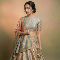 Lehenga set with blue patterned blouse and flared cream skirt, pink dupatta