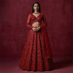 Red sequined designer lehenga with cropped long-sleeve blouse and full skirt