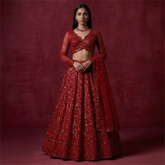 Red sequin lehenga with matching cropped blouse, sheer embroidered sleeves, and dupatta