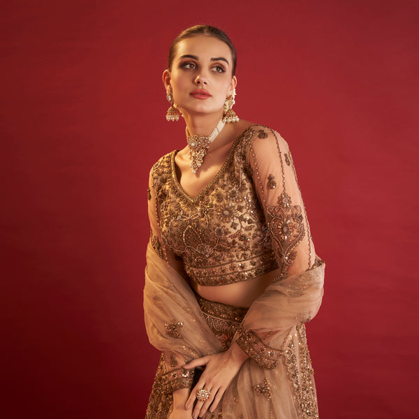 Elegant golden lehenga with beads showcasing intricate embroidery and a stylish crop top design